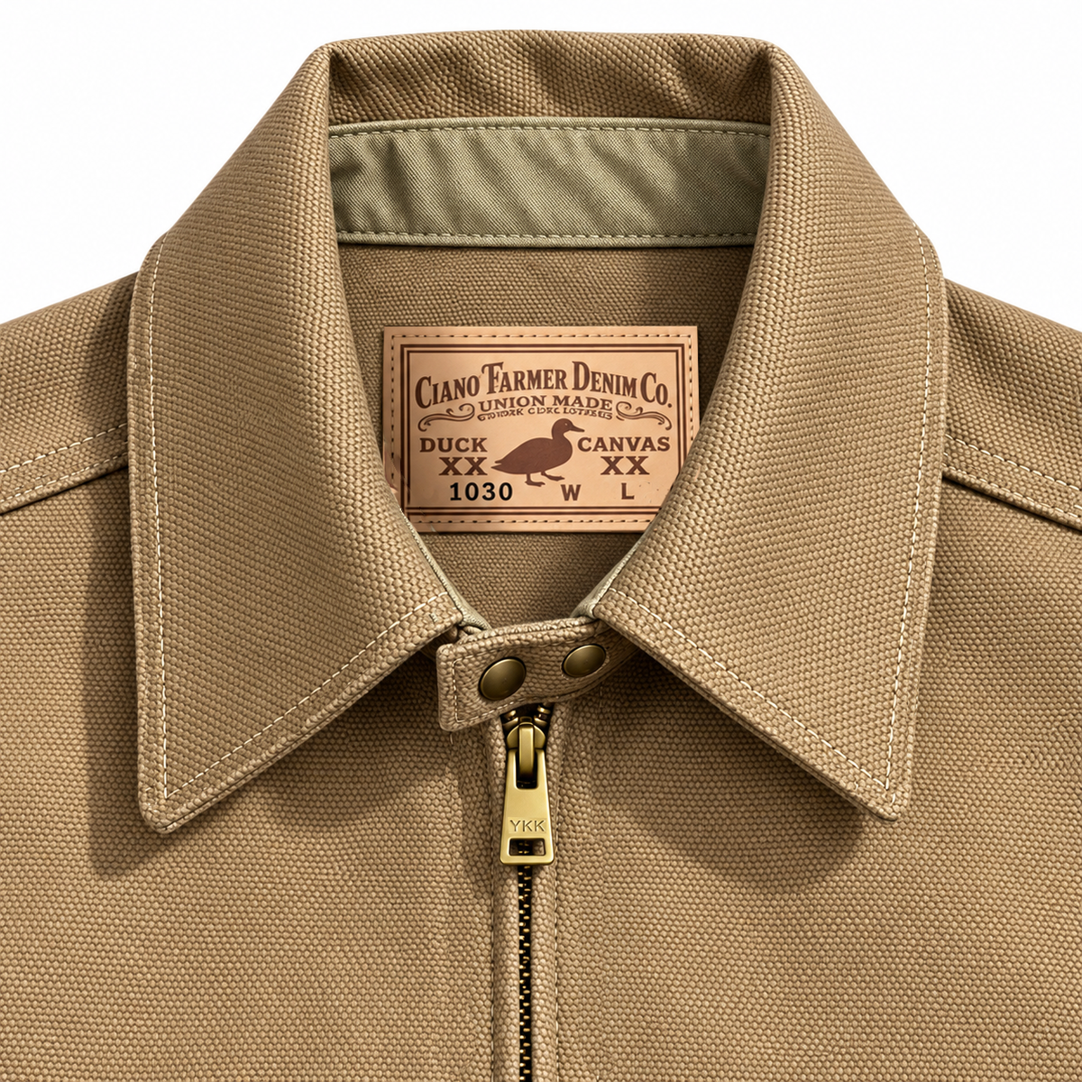 Close-up of a tan canvas work jacket collar with a brass zipper and a visible Ciano Farmer Denim Co. neck label.