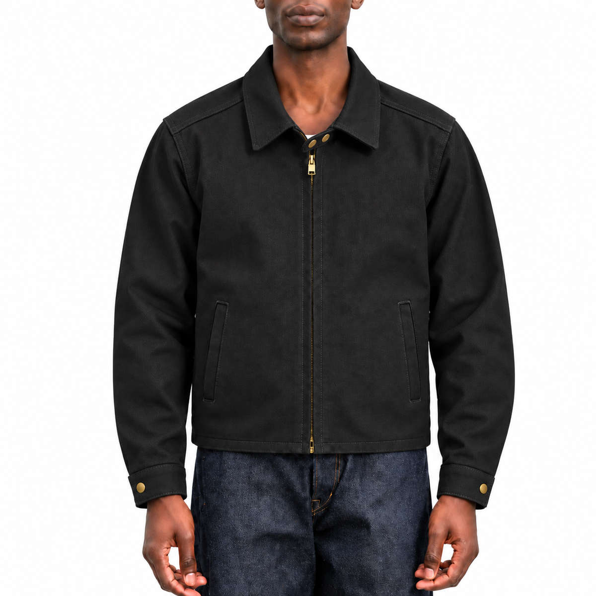A man wearing a black zip-up jacket with gold-tone hardware and blue jeans, shown from the chin down against a plain white background.