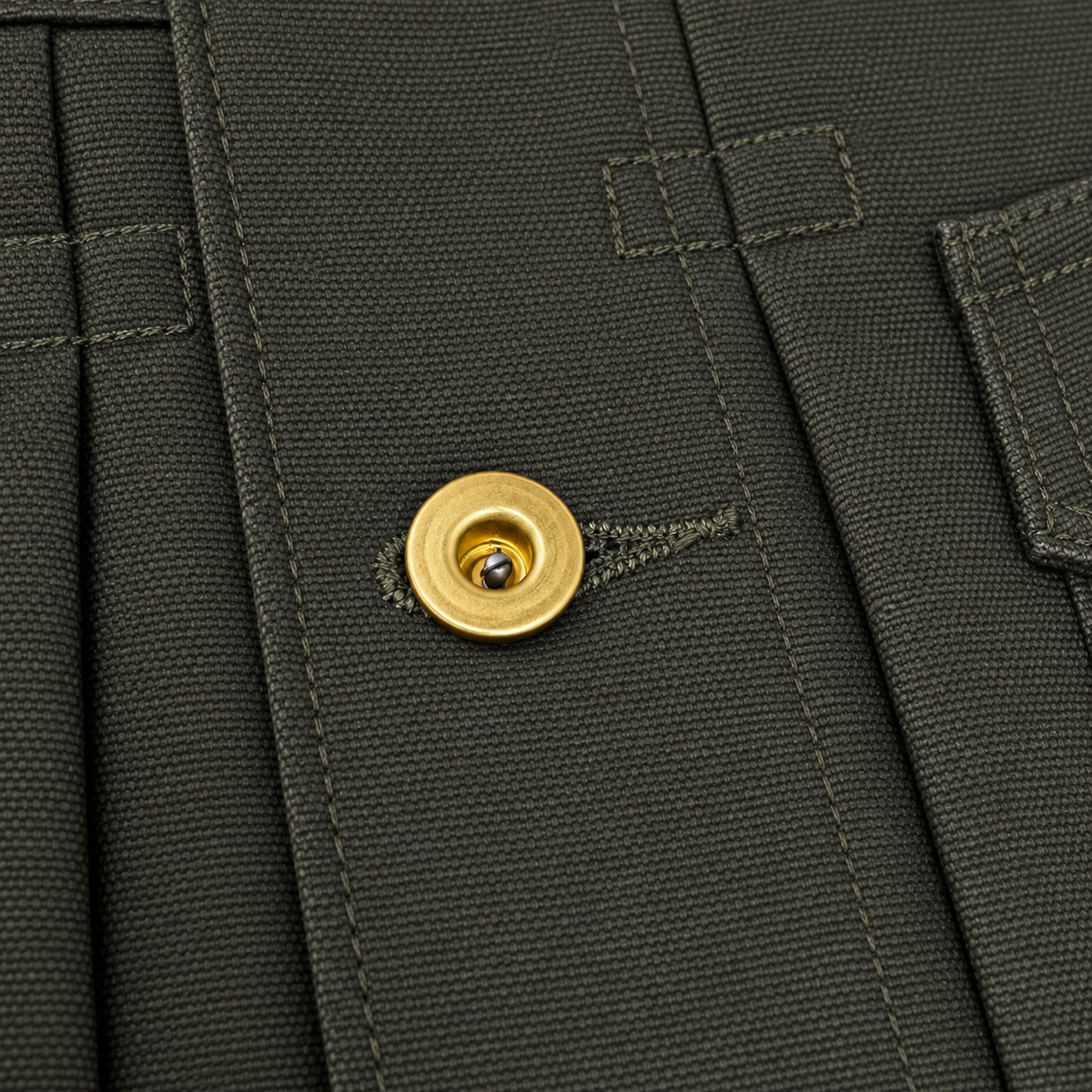 Close-up of dark olive green pleated fabric with a gold snap button closure and matching stitching.